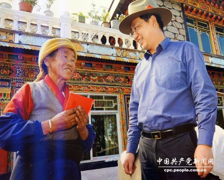 “科学发展 成就辉煌”图片展·党建·图为江苏第五六批援藏干部、西藏曲水县委书记周广智(右)资助生活困难的藏族群众